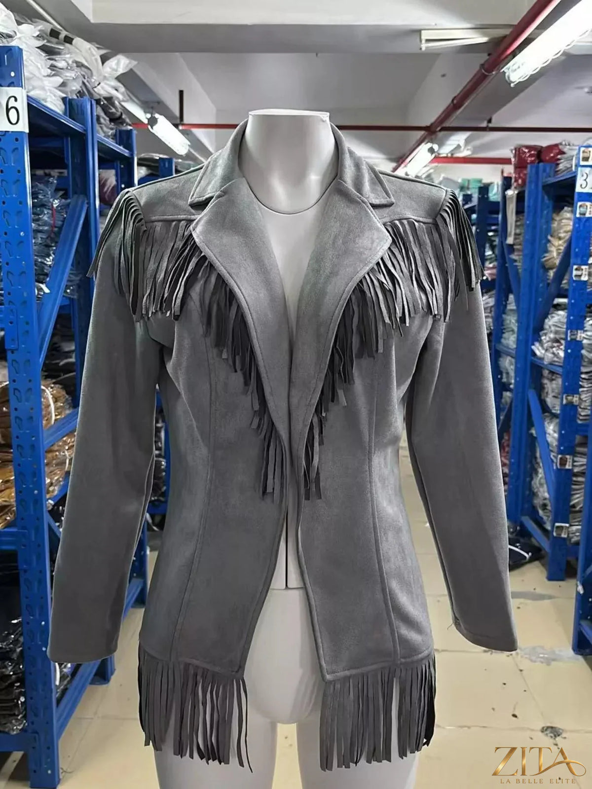 Western-inspired fringed open front jacket by Trendsi, featuring tan fabric, fringe details, and a stylish open design.