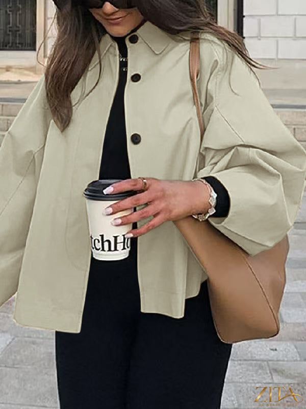 Women's French-style loose mid-length trench coat by Zita La Belle Elite, featuring classic lapels and a belted waist.