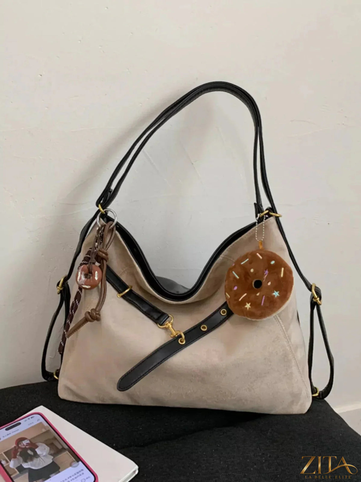 Zita La Belle Elite adjustable strap handbag with decorative charm, featuring a sleek design and sturdy handle.