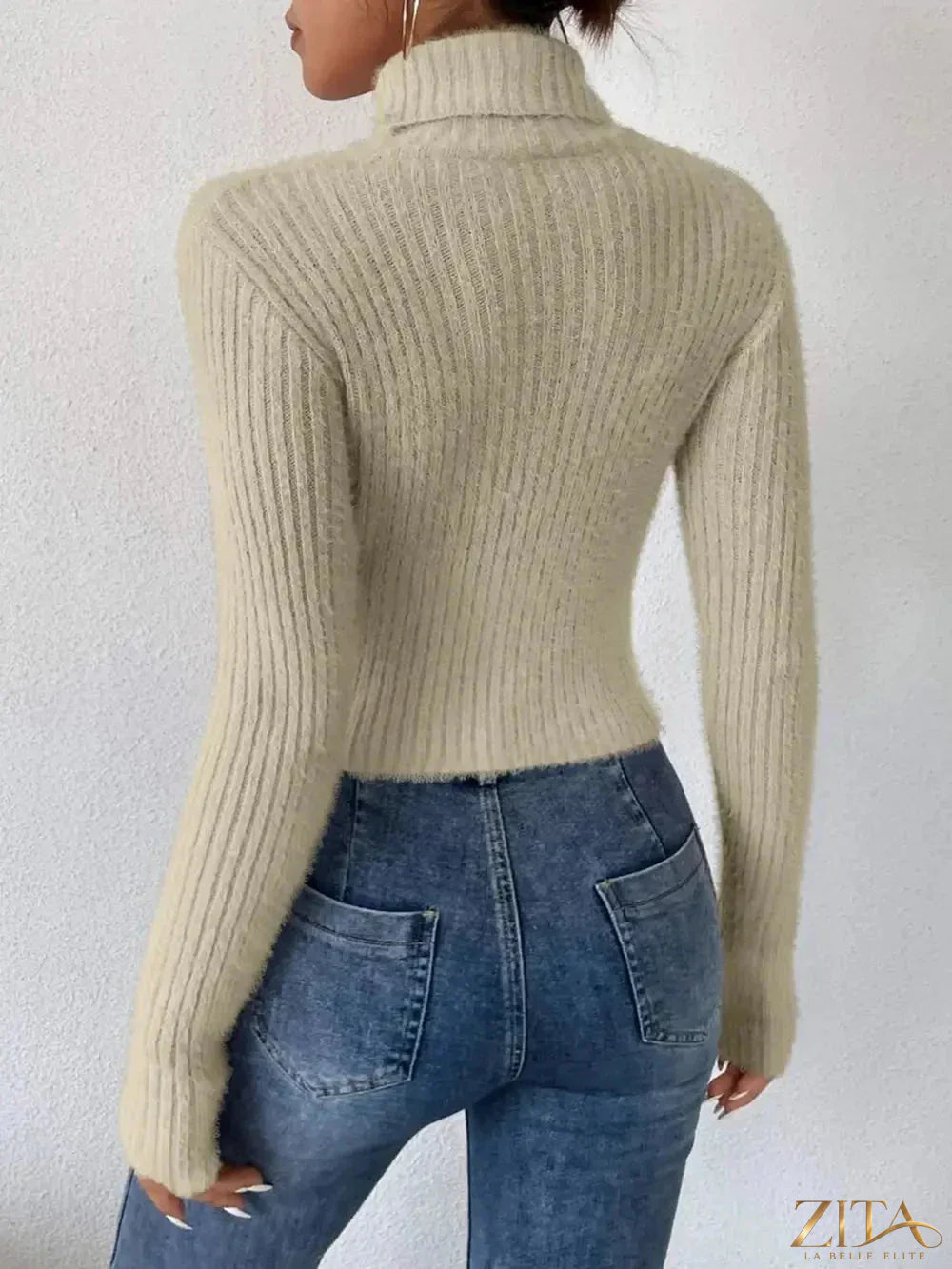 Close-up of a ribbed turtleneck long sleeve sweater from Trendsi in neutral color, highlighting its textured knit fabric.