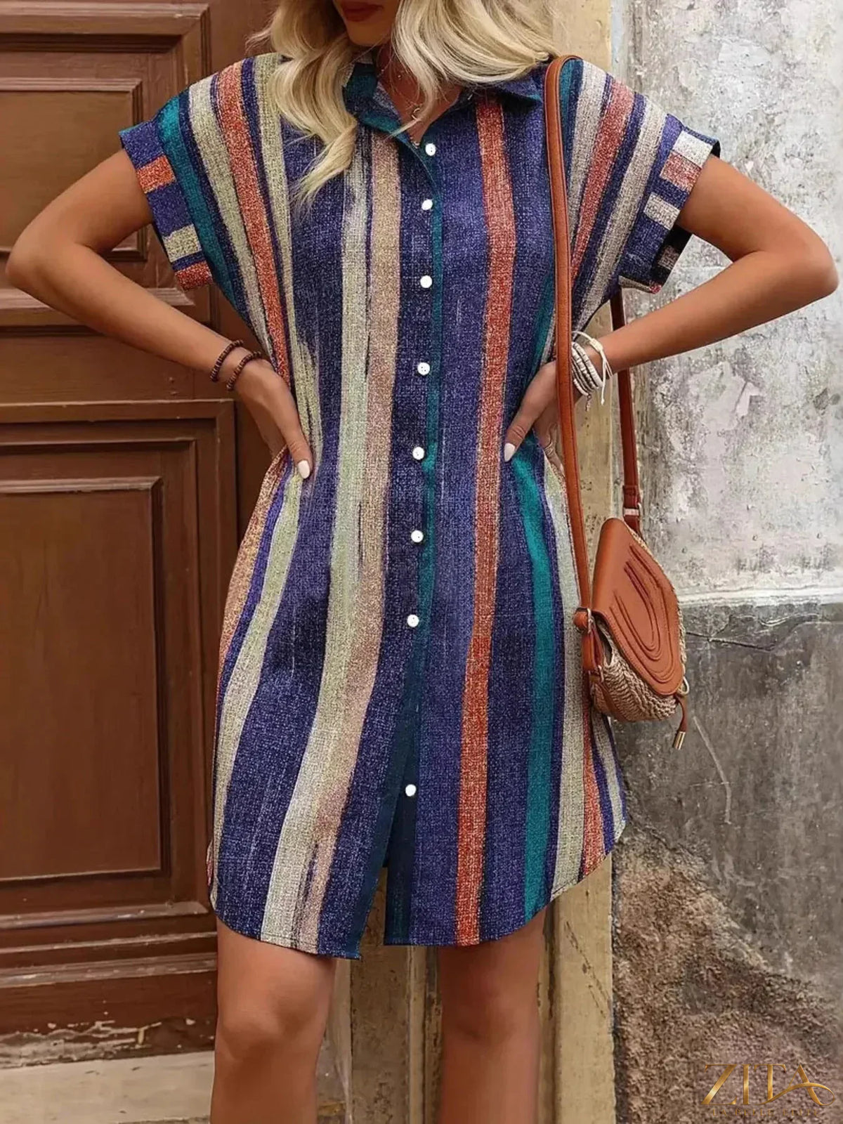 Zita La Belle Elite striped button-front shirt dress with long sleeves and a relaxed fit, featuring vertical black and white stripes.
