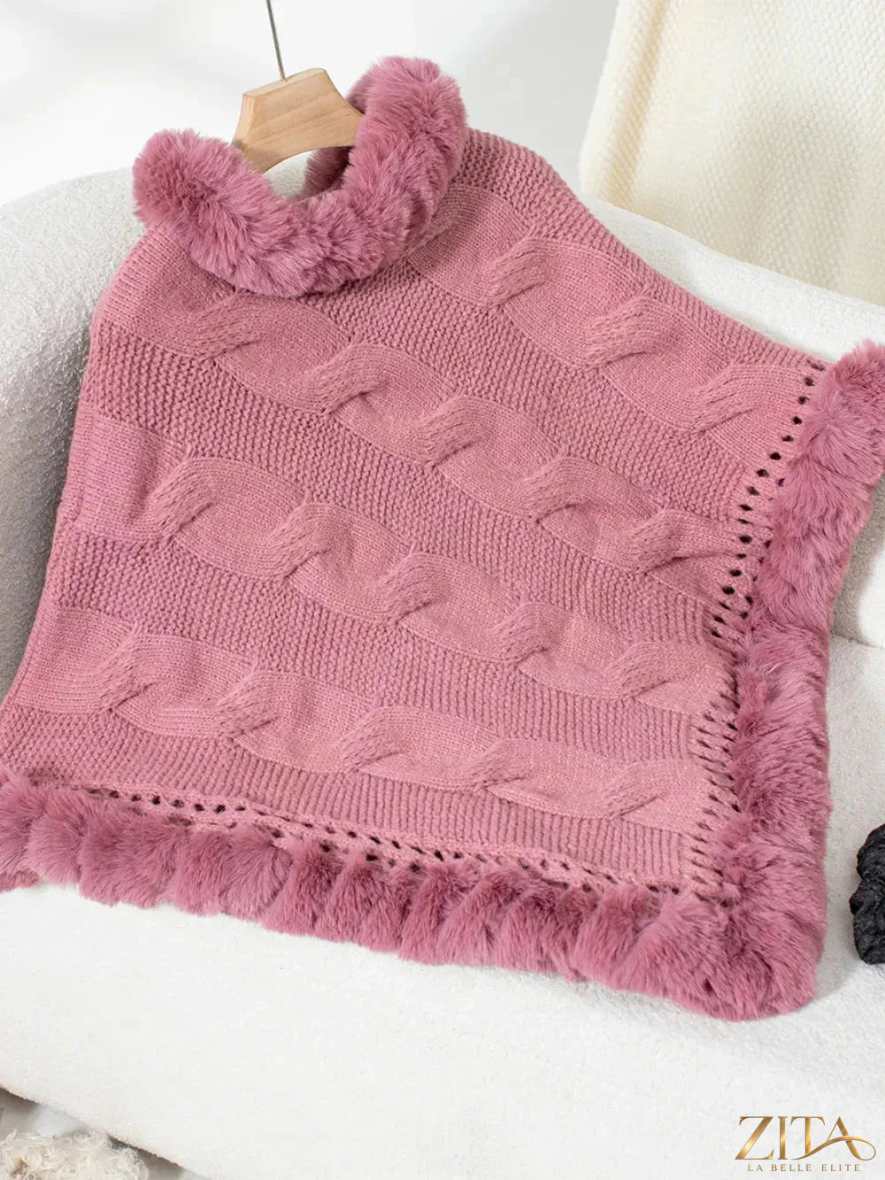 Fuzzy hem cable-knit poncho in warm neutral tones, featuring a cozy, textured design and relaxed fit from Trendsi.