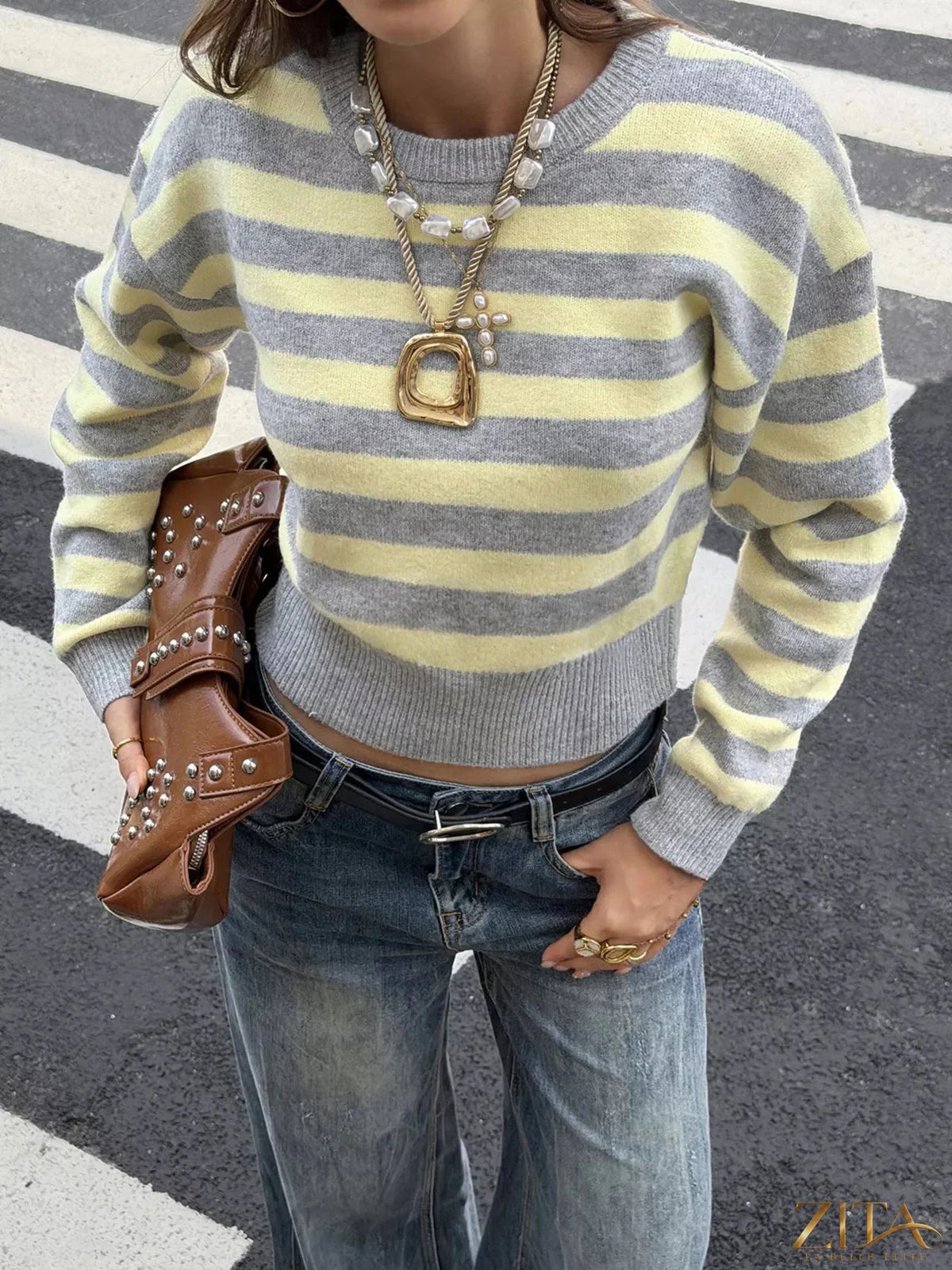 Casual striped cropped sweater by Trendsi with long sleeves and a relaxed fit, featuring colorful horizontal stripes on soft fabric.