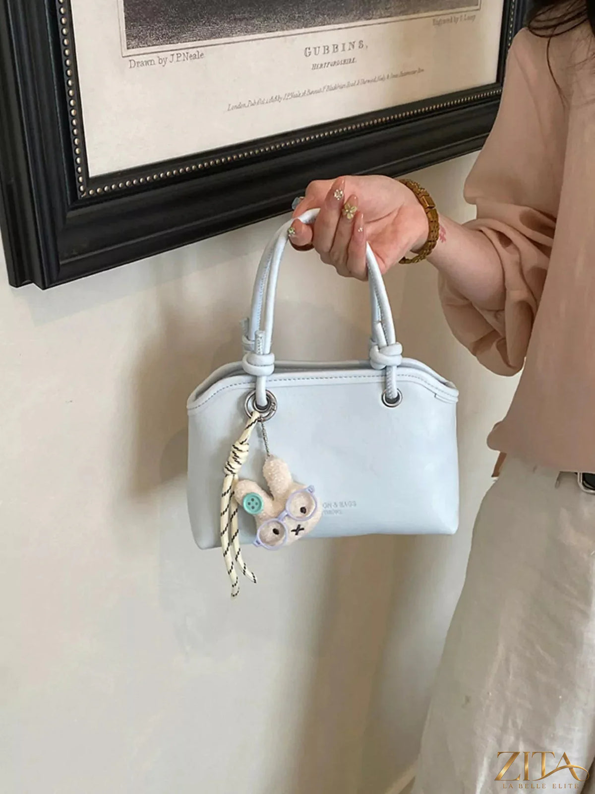Trendsi PU leather handbag with sleek design and silver hardware, featuring a top handle and adjustable shoulder strap.