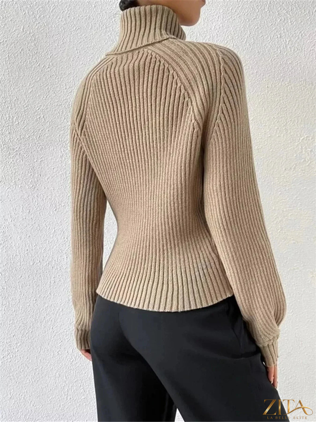 Zita La Belle Elite ribbed knit turtleneck sweater in neutral color, close-up showing textured fabric and high collar.