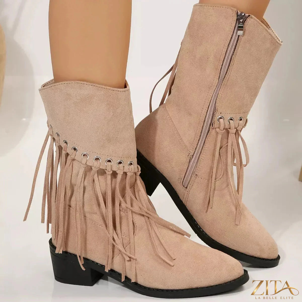 Zita La Belle Elite fringe Western block heel boots with leather upper and decorative fringe details on a rustic background.