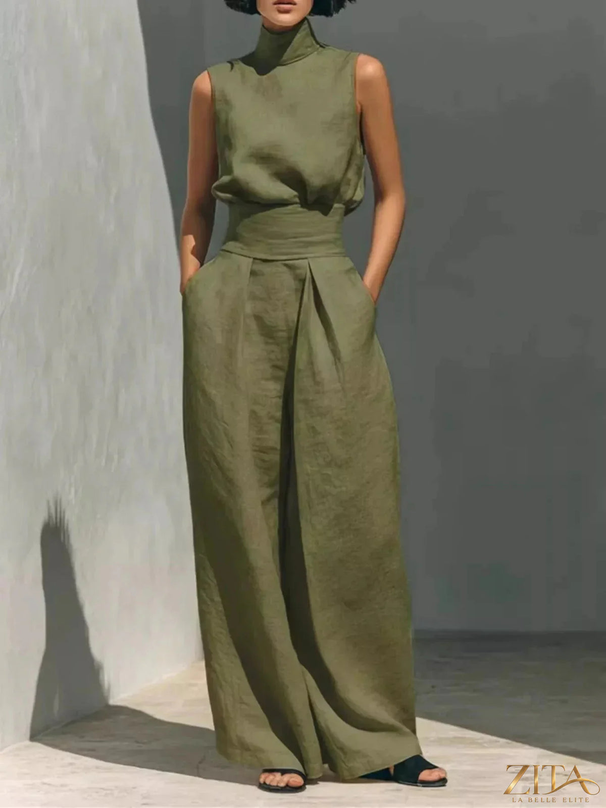 Sleeveless turtleneck top and wide-leg pants set by Trendsi, featuring a stylish, coordinated outfit in neutral tones.
