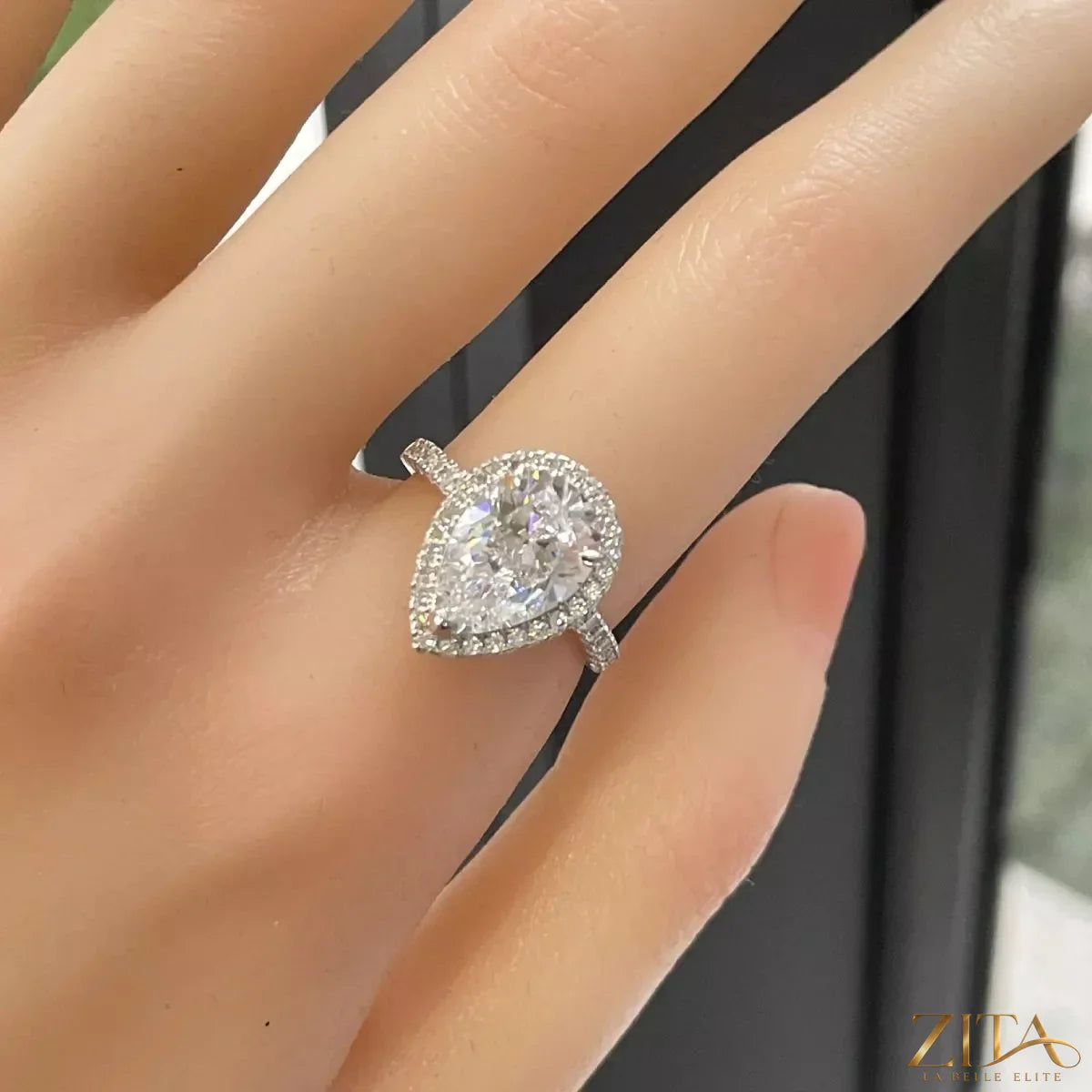 Sterling silver moissanite teardrop ring with 4 carats, featuring a sparkling teardrop-shaped gemstone.