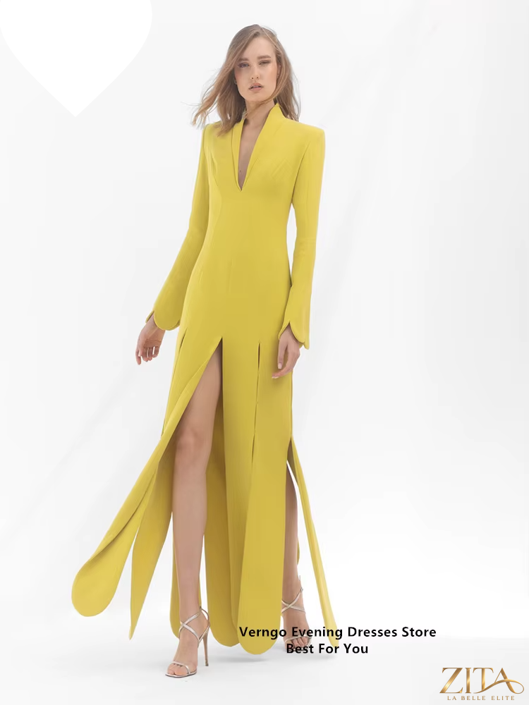 Yellow satin long sleeve formal A-line gown with V-neck and split, by Zita La Belle Elite. Elegant dress with flowing fabric.