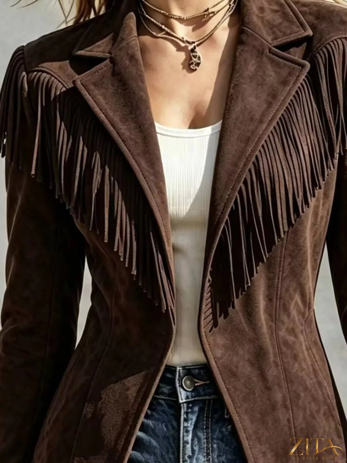 Western-inspired fringed open front jacket from Trendsi, showing brown suede-like fabric with fringe details and open front design.