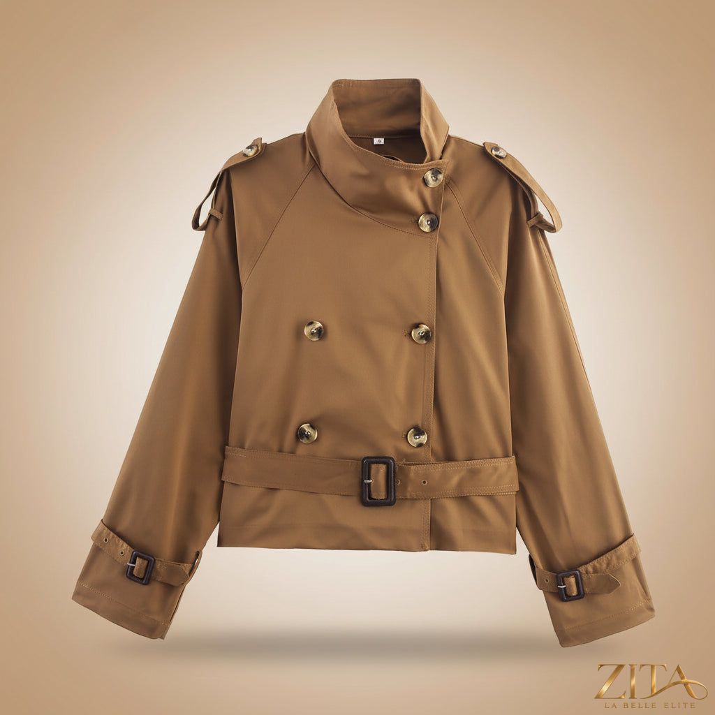 Women's short trench coat with notch collar and belt buckle, by Zita La Belle Elite, featuring stylish button details and classic design.