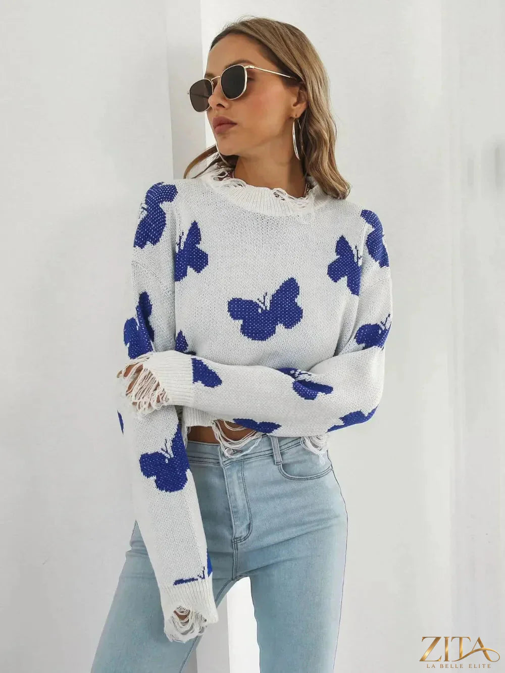 Distressed butterfly design cropped sweater by Zita La Belle Elite, featuring a stylish, trendy knit with ripped details and a relaxed fit.