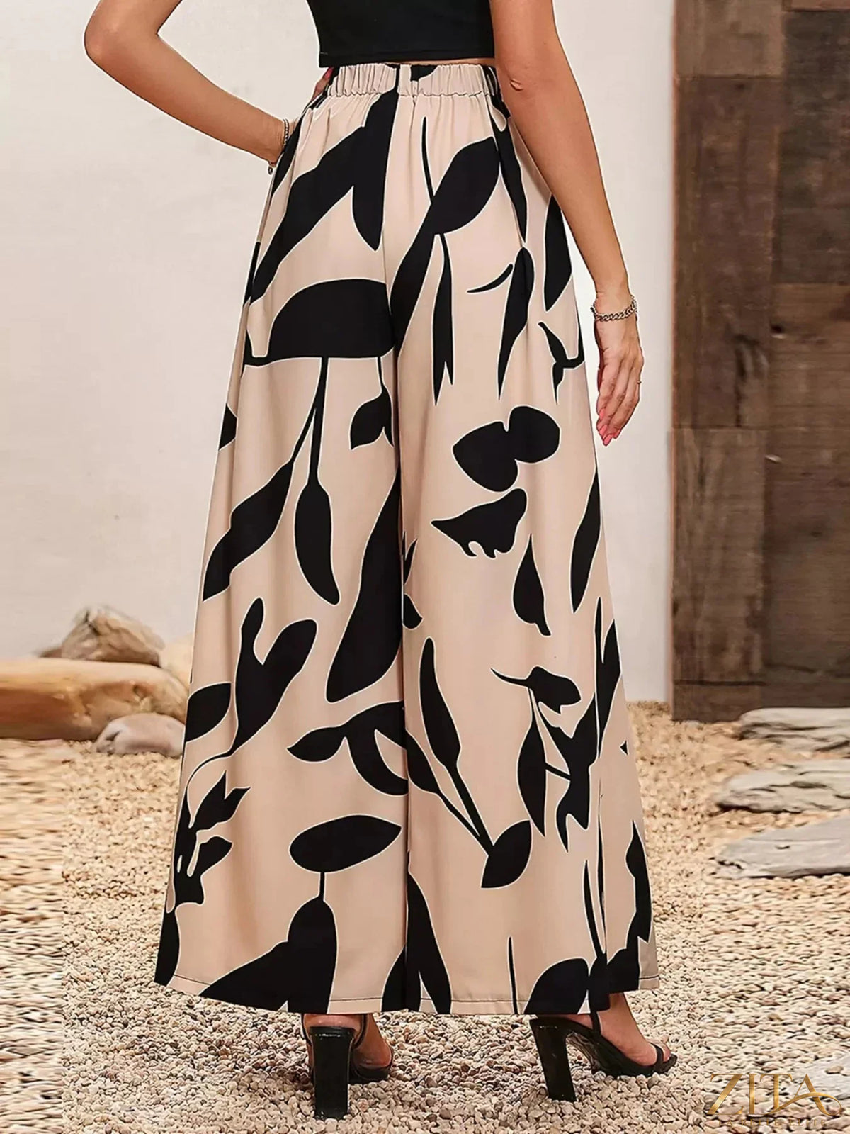 Zita La Belle Elite printed wide-leg pants with a flowing design and colorful floral pattern, full-length on a model.