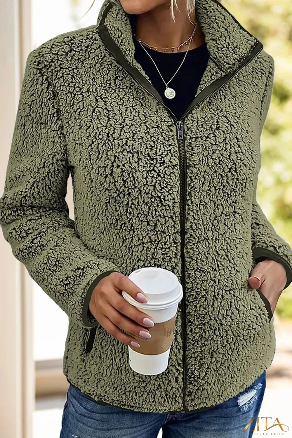 Black pocketed zip-up turtleneck jacket by Trendsi, featuring a snug fit, front pockets, and a high neckline for stylish warmth.