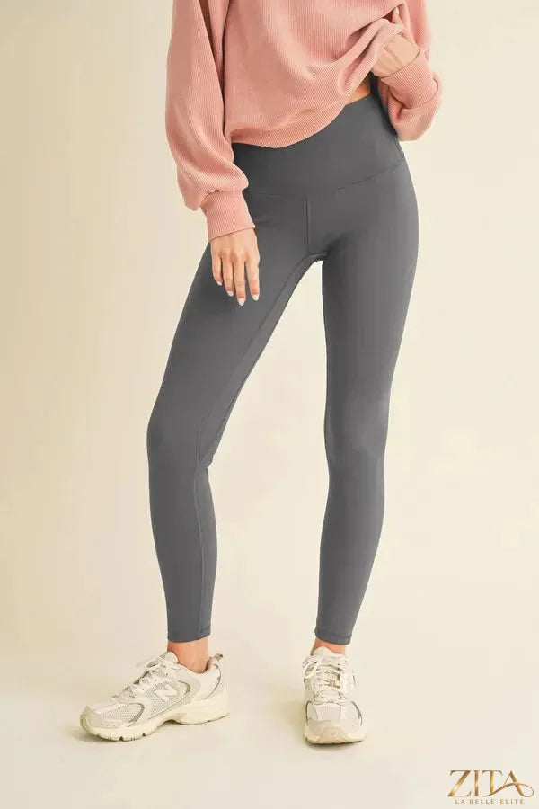 Yelete high waisted fleece-lined leggings in black, showcasing their soft, cozy interior and snug fit for warmth and comfort.