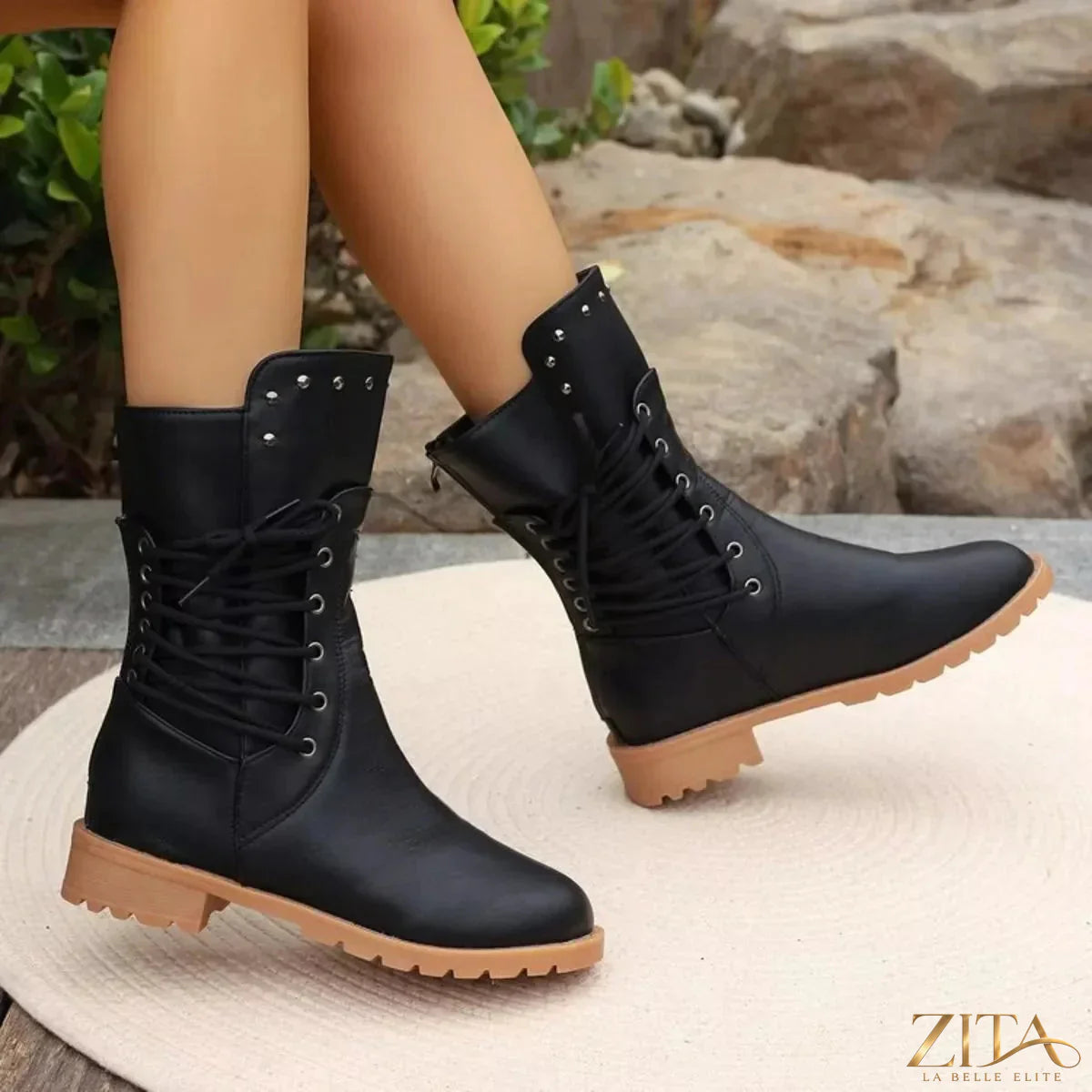 Black studded lace-up boots from Trendsi featuring metal eyelets, chunky heel, and textured leather finish.