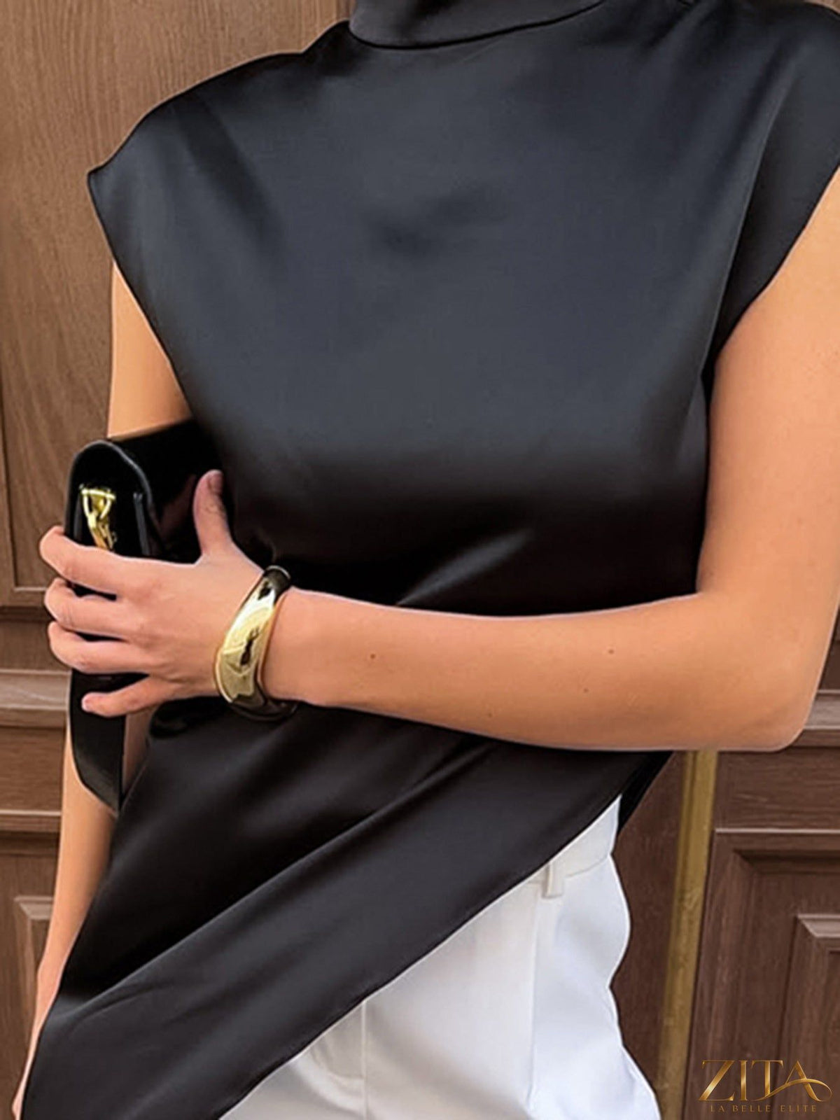 Zita La Belle Elite asymmetrical hem turtleneck blouse showing a stylish, fitted design with a high neckline and unique hem detail.