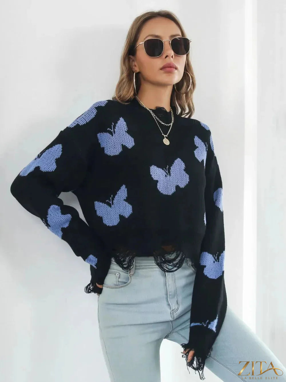 Zita La Belle Elite distressed butterfly cropped sweater featuring a worn-in look and floral butterfly design on soft knit fabric.