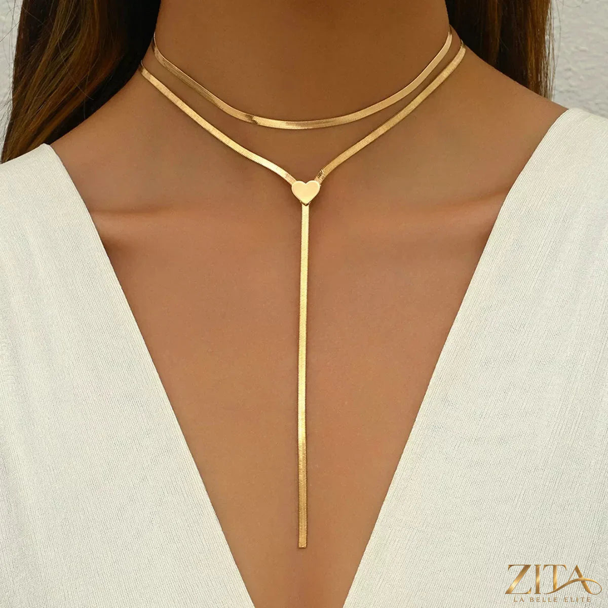 Two 18K gold-plated heart necklaces by Zita La Belle Elite, featuring delicate chain links and polished heart pendants.