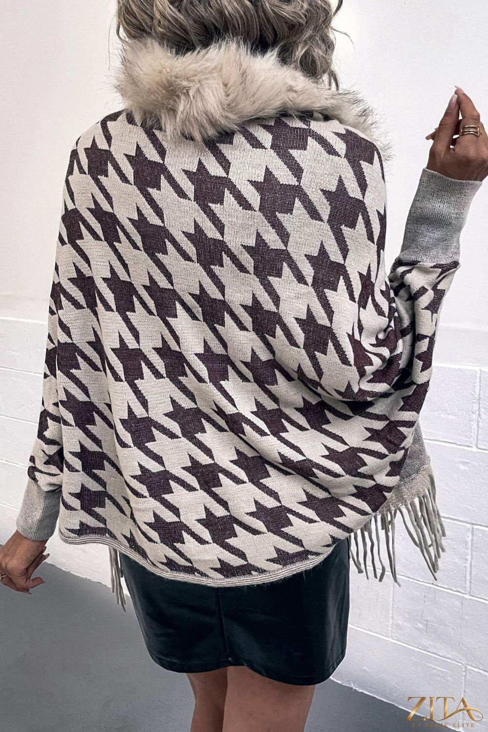 Houndstooth fringe hem poncho in black and white, stylish fashion piece with fringe detailing, designed by Trendsi.