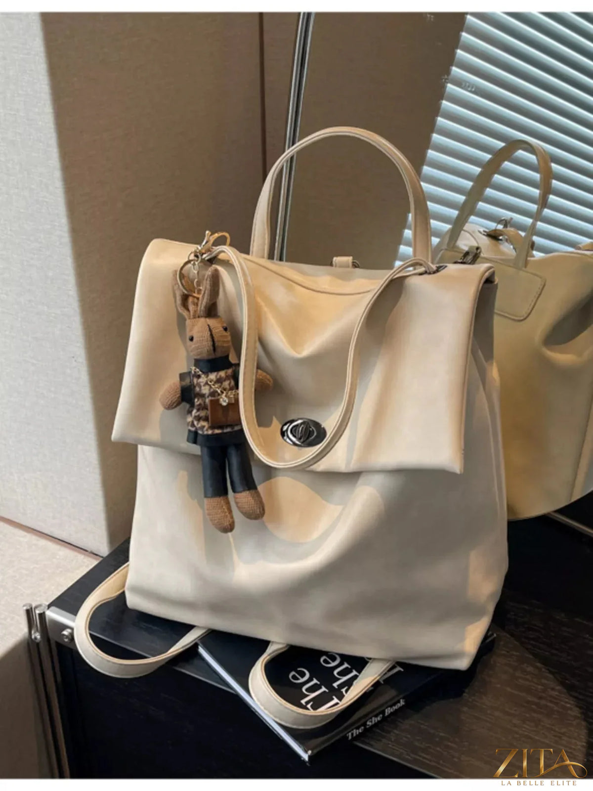 Leather flap backpack bag by Trendsi featuring a stylish design with adjustable straps and a front flap closure.