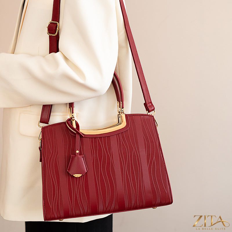 Zita La Belle Elite leather top handle handbag with sturdy strap and sleek design, displayed on a plain background.