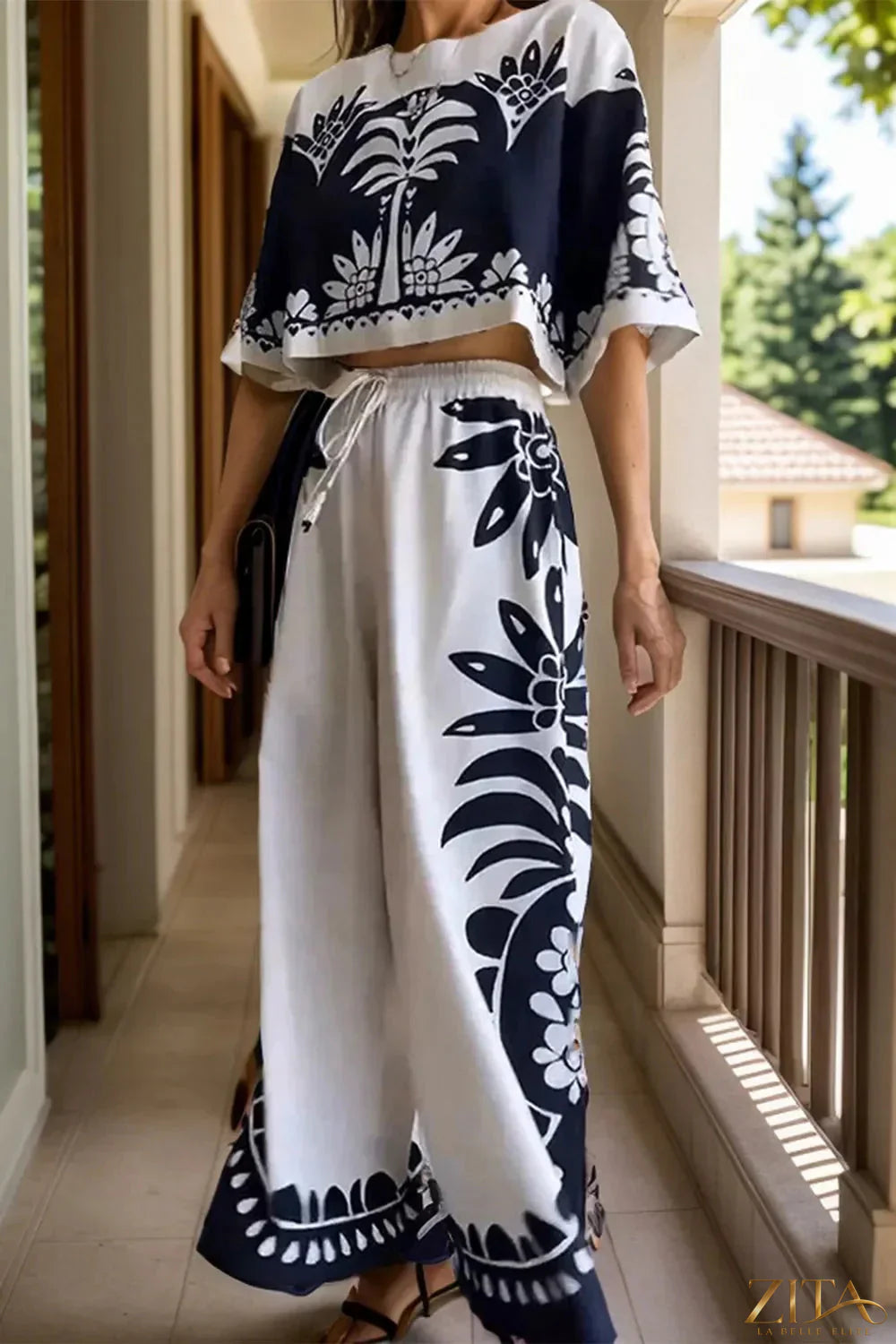 Printed half sleeve top and wide-leg pants set by Zita La Belle Elite, featuring a stylish coordinated outfit with bold pattern.