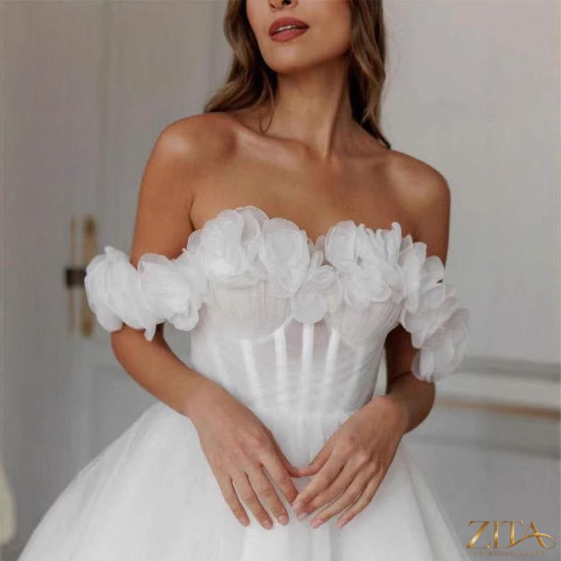 Lace off-shoulder mini wedding dress by Zita La Belle Elite featuring delicate lace details and a fitted silhouette.