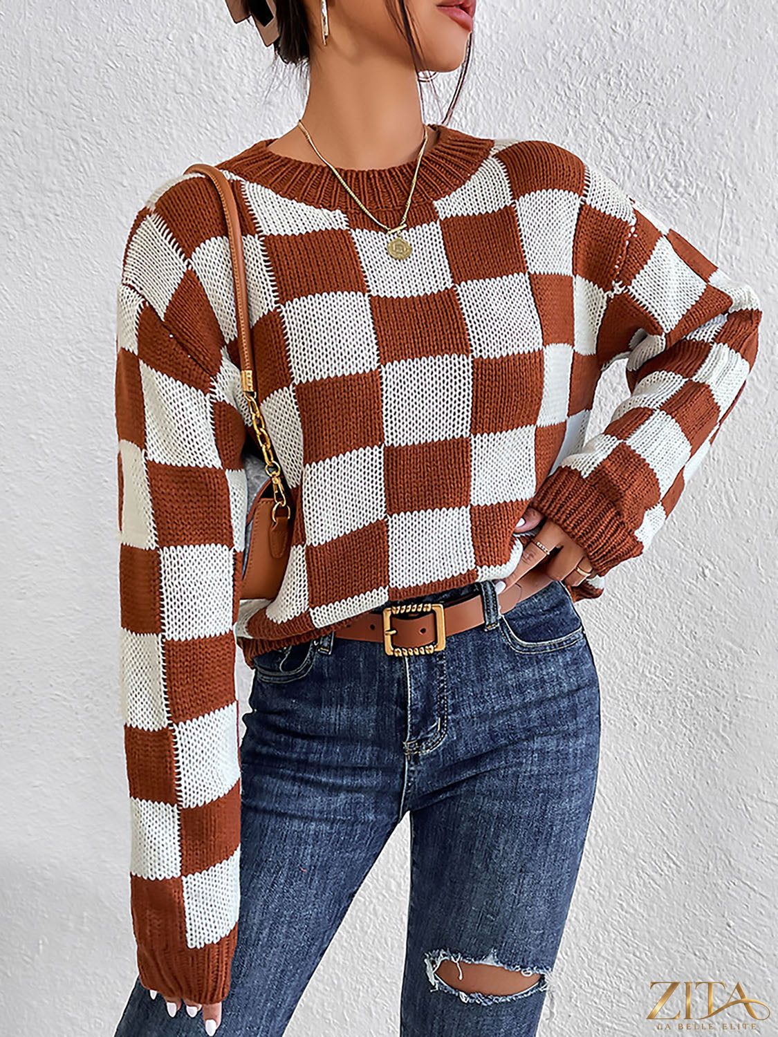 Checkered round neck sweater by Trendsi featuring a bold black and white checkered pattern and a cozy, casual fit.