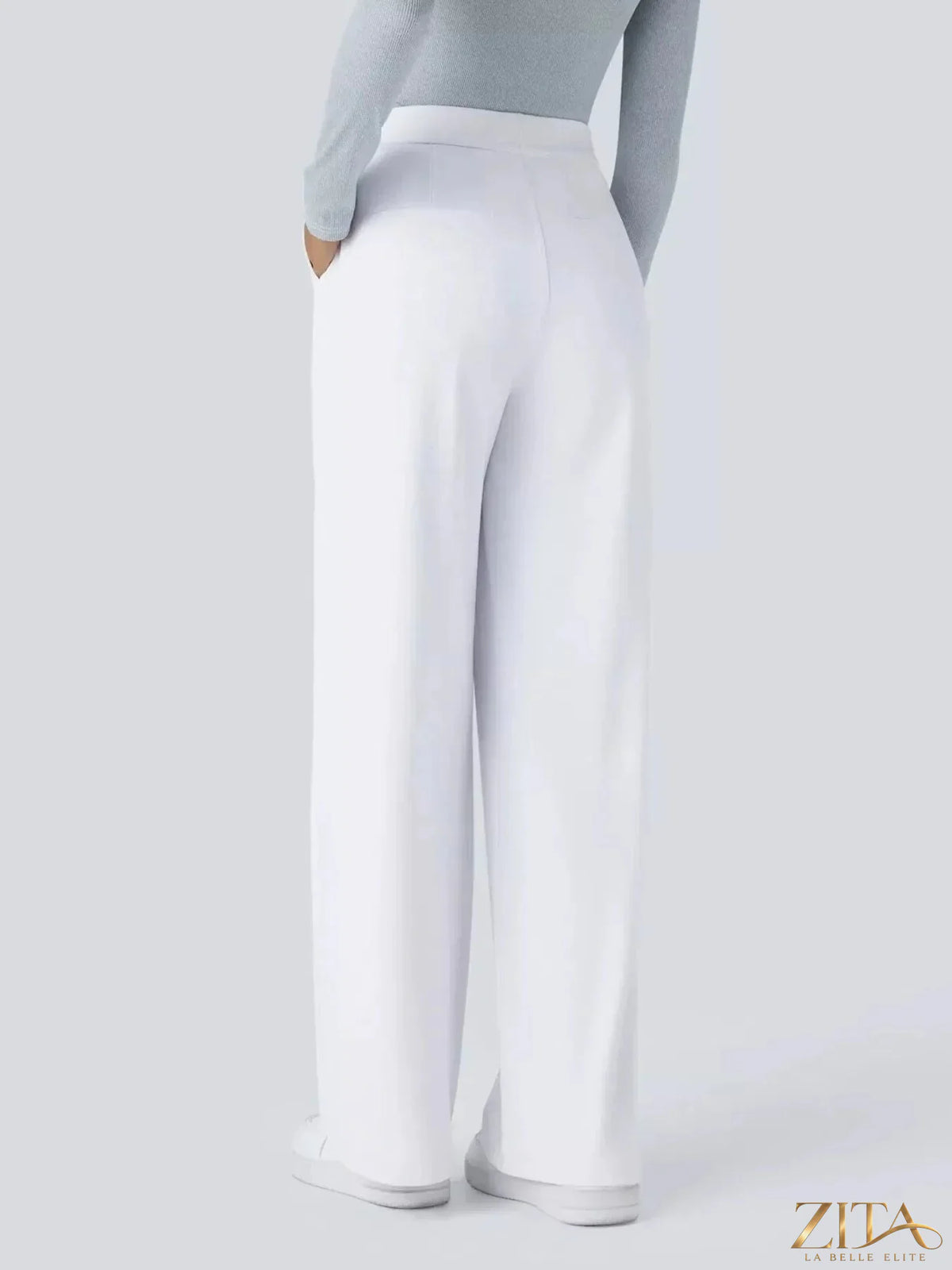 Zita La Belle Elite wide leg pants in soft fabric with high waist and relaxed fit, shown on a woman in a stylish indoor setting.
