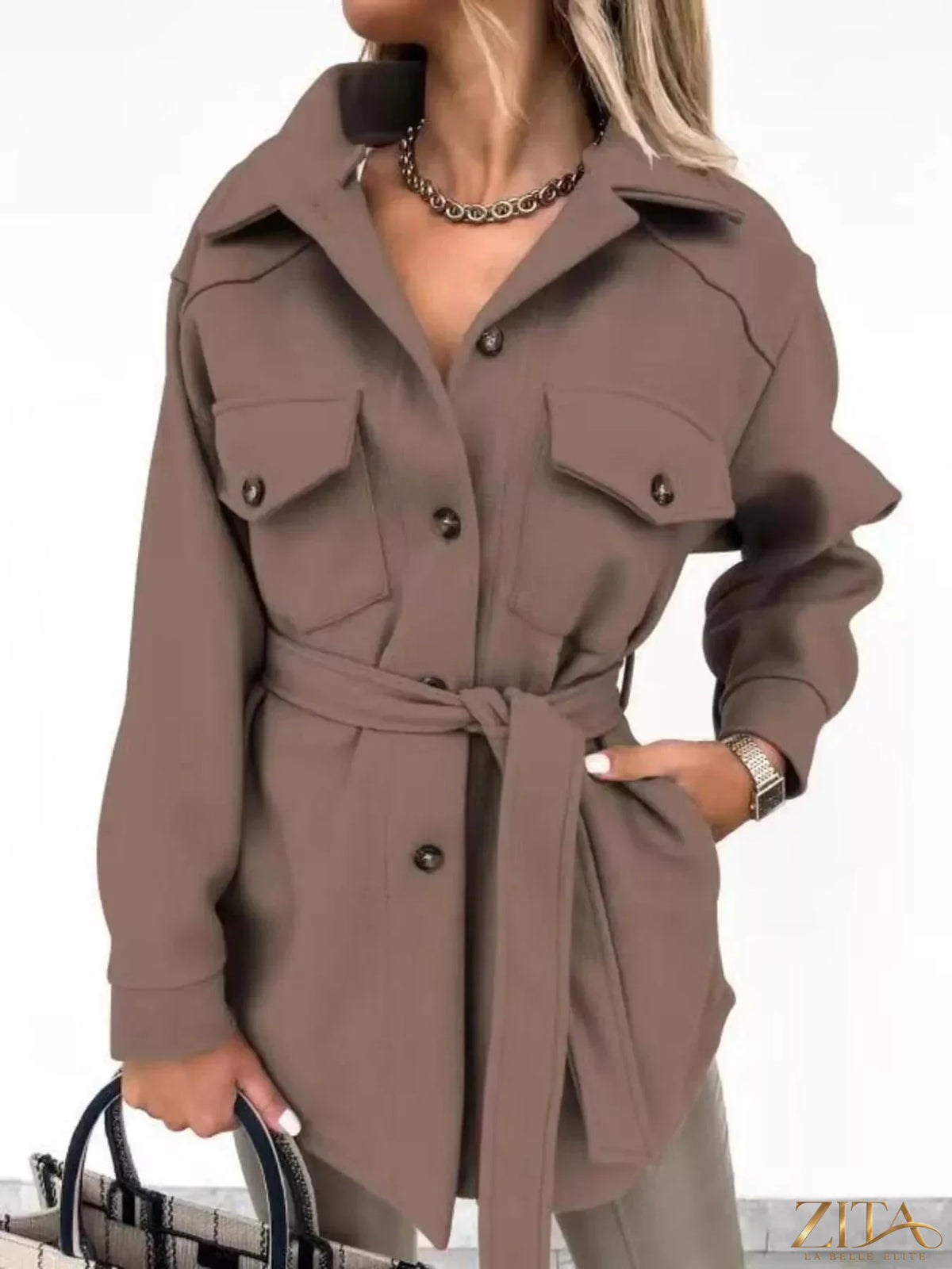 Zita La Belle Elite button-down tie waist coat showing a tailored beige outerwear with front buttons and a waist tie detail.