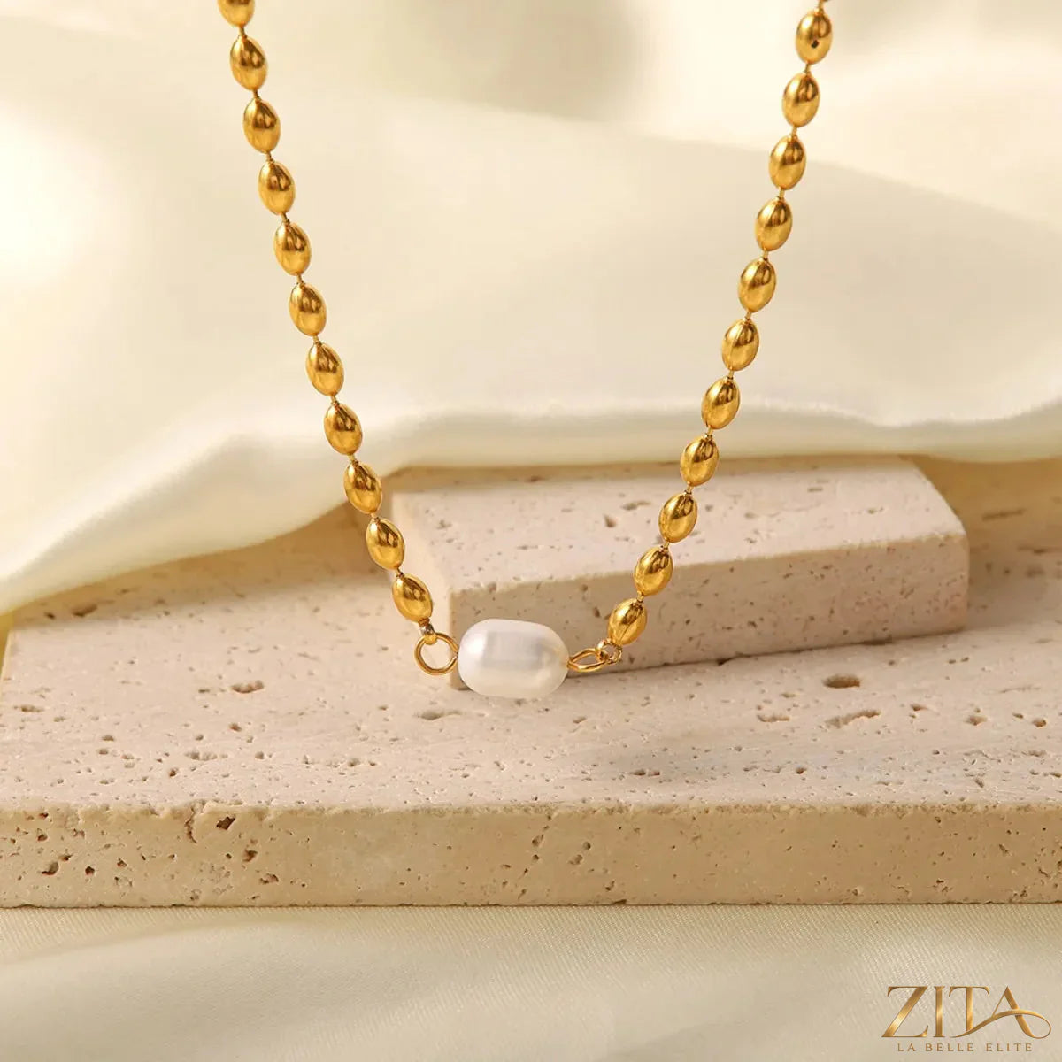 Pearl and gold chain jewelry set featuring a necklace and bracelet with elegant pearl accents and gold links.