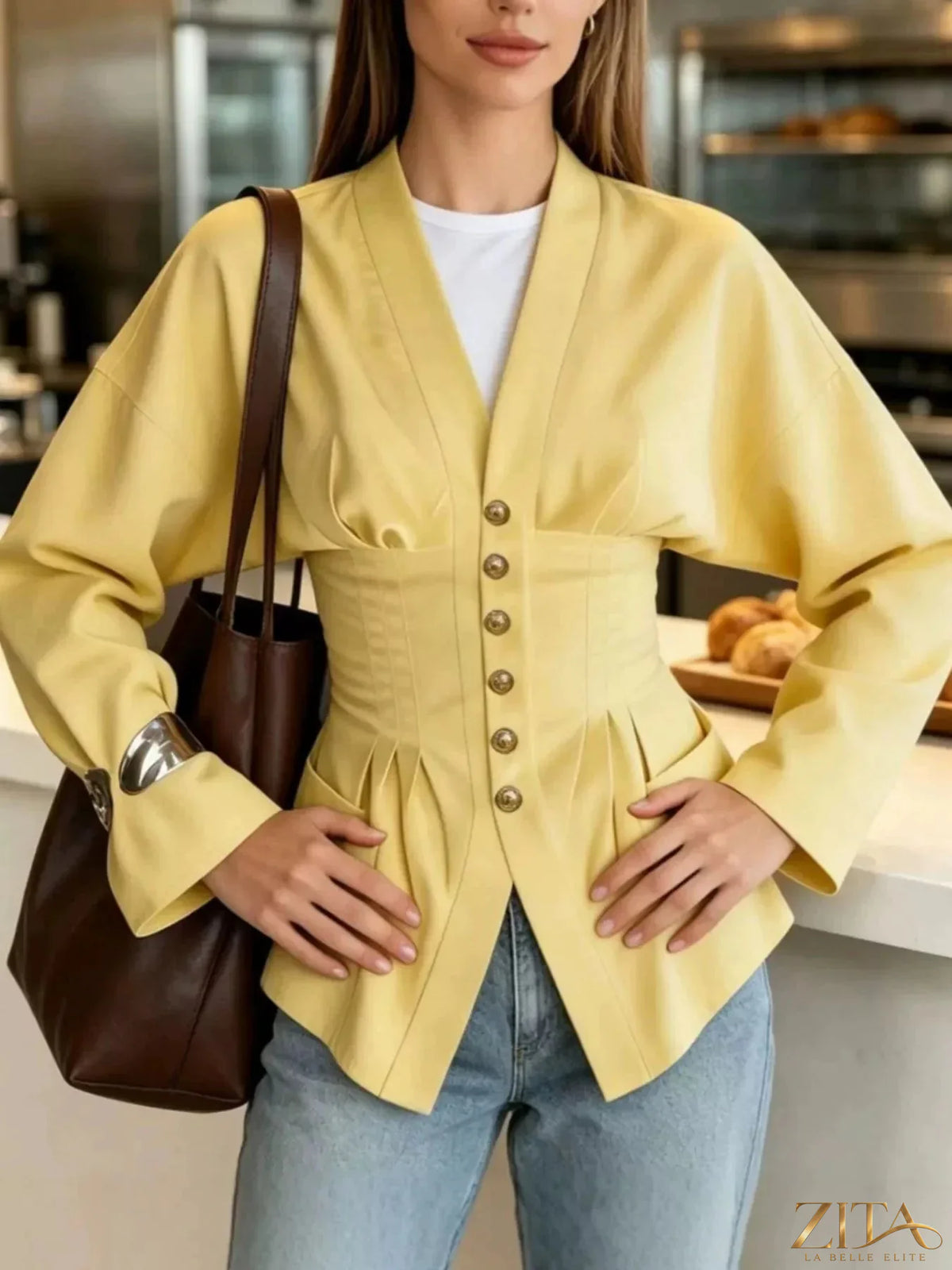 Zita La Belle Elite pleated waist blouse with button detail, showing a flowy fabric and stylish design on a model.