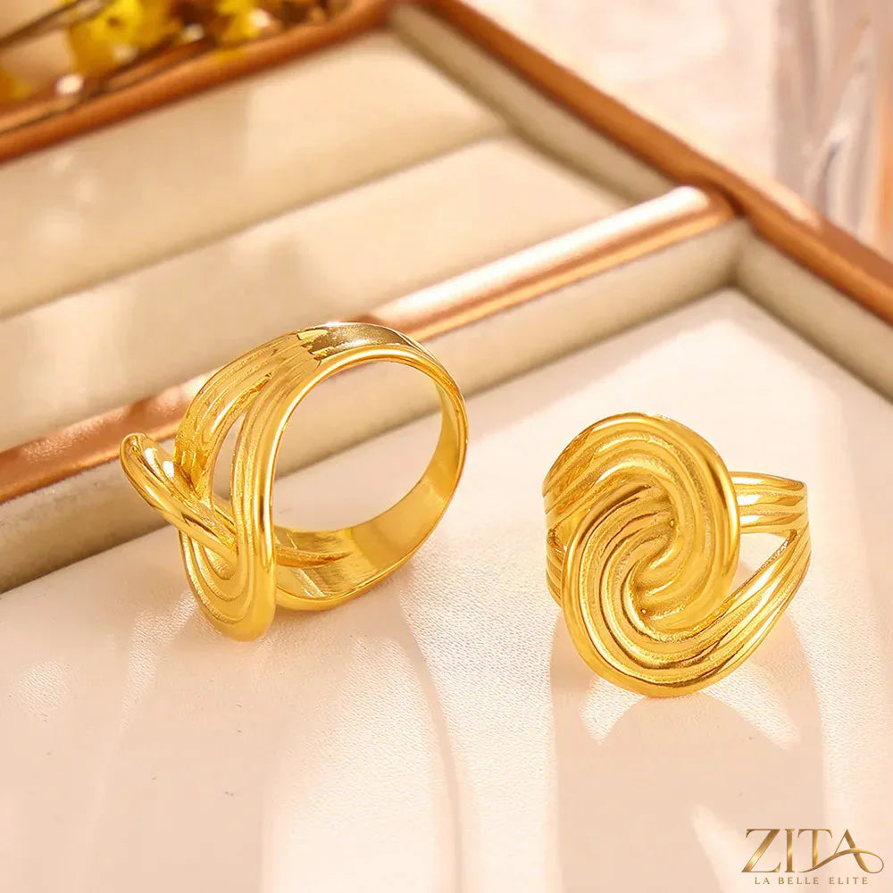 Elegant 18K gold-plated twisted ring by Zita La Belle Elite, showcasing a sleek and stylish design on a white background.