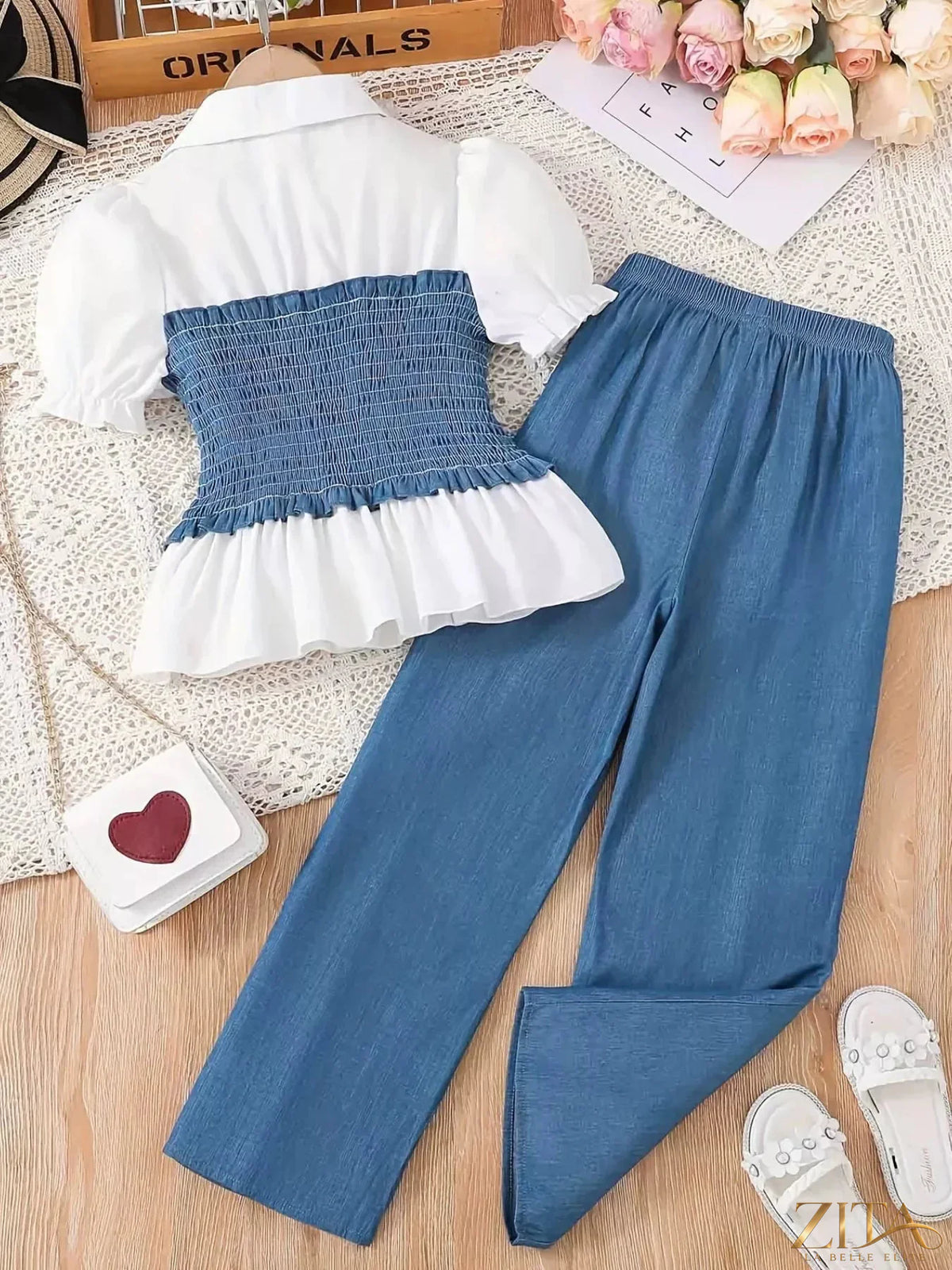 Children's smocked blouse and wide-leg pants set by Zita La Belle Elite, featuring a cute blouse with smocking and matching wide-leg pants.