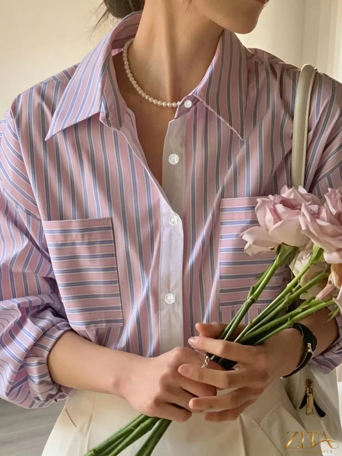 Zita La Belle Elite striped button-down shirt showing a classic collar, long sleeves, and blue and white vertical stripes.