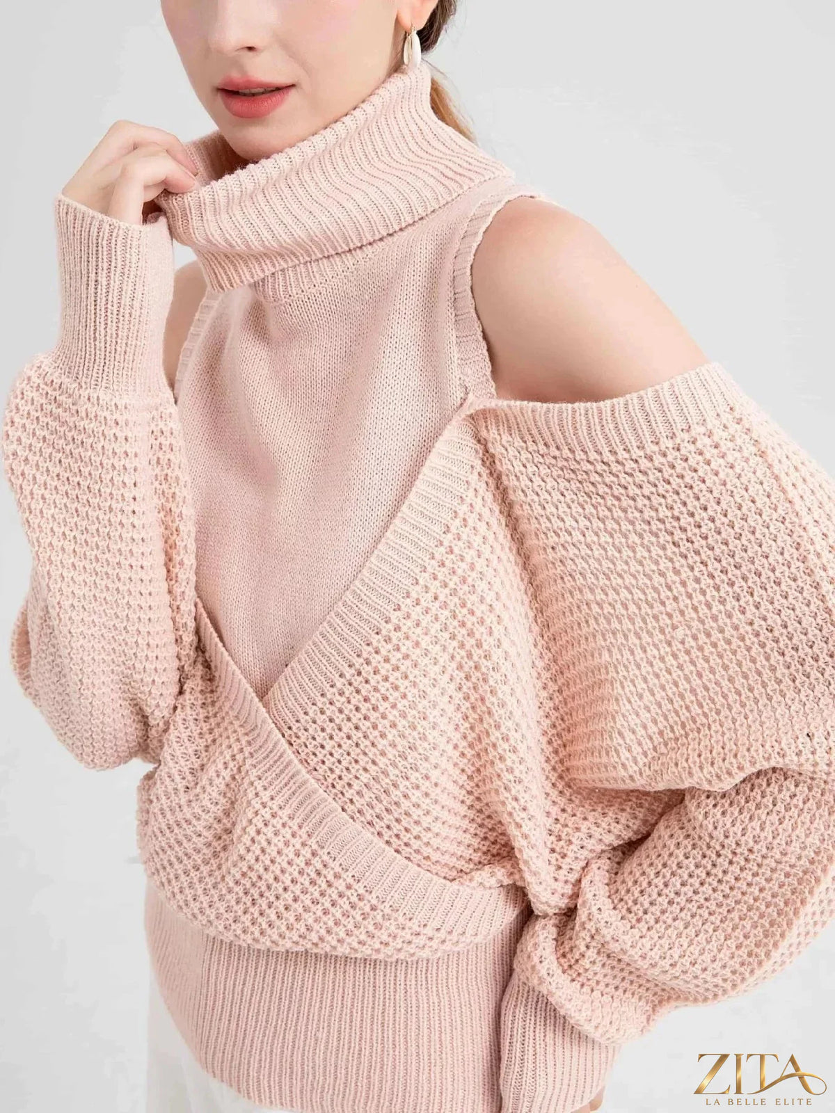 Waffle knit cold shoulder turtleneck sweater from Trendsi featuring long sleeves and a cozy, textured design.