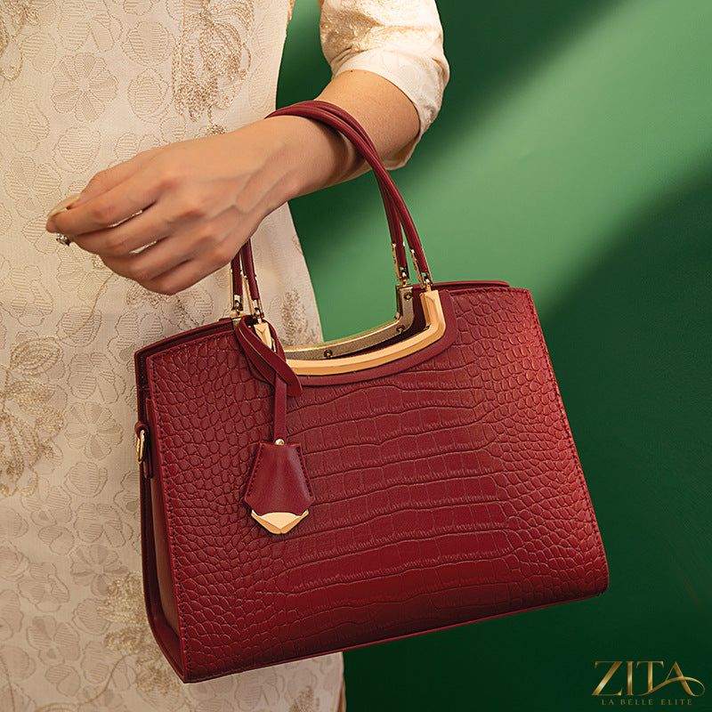 Zita La Belle Elite crocodile embossed leather top handle handbag with gold-tone hardware and structured design.