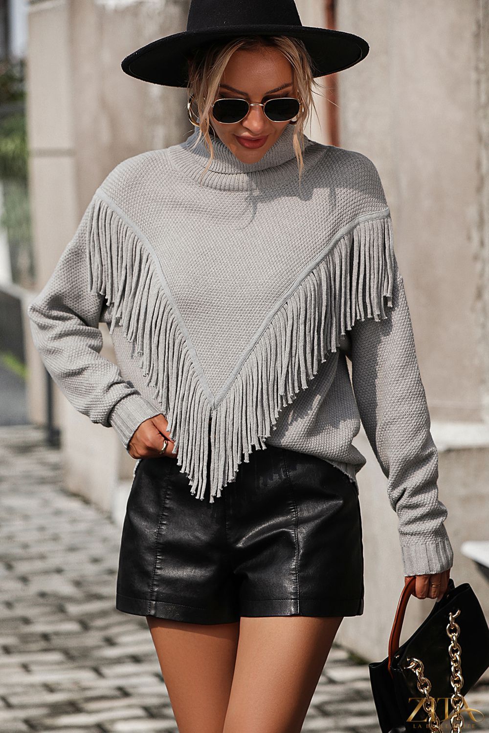 Long sleeve turtle neck pullover sweater with tassel front by Trendsi, featuring a cozy fit and stylish detail.
