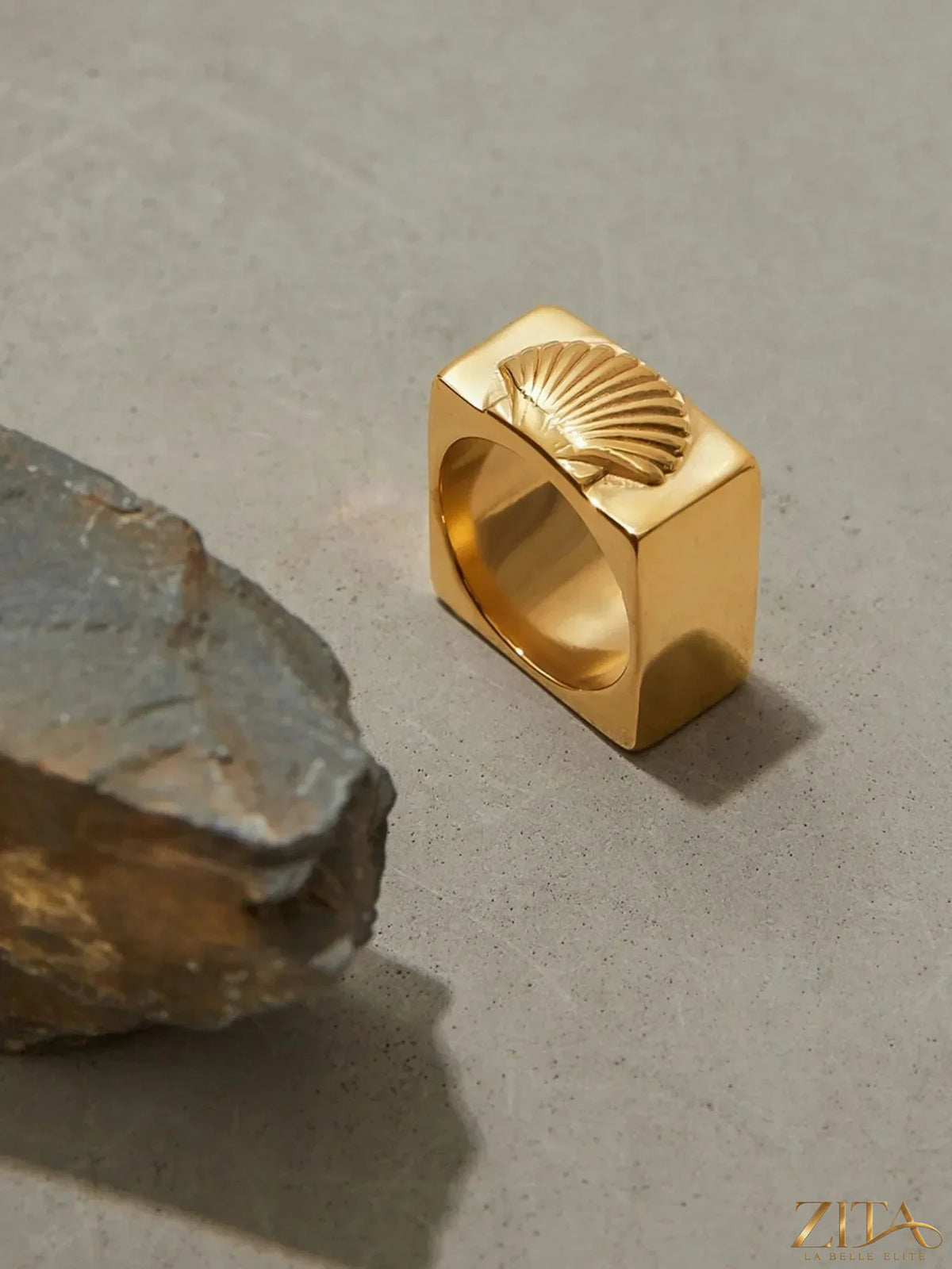 Vintage shell pattern gold signet ring by Zita La Belle Elite, showcasing intricate shell design on a polished gold band.