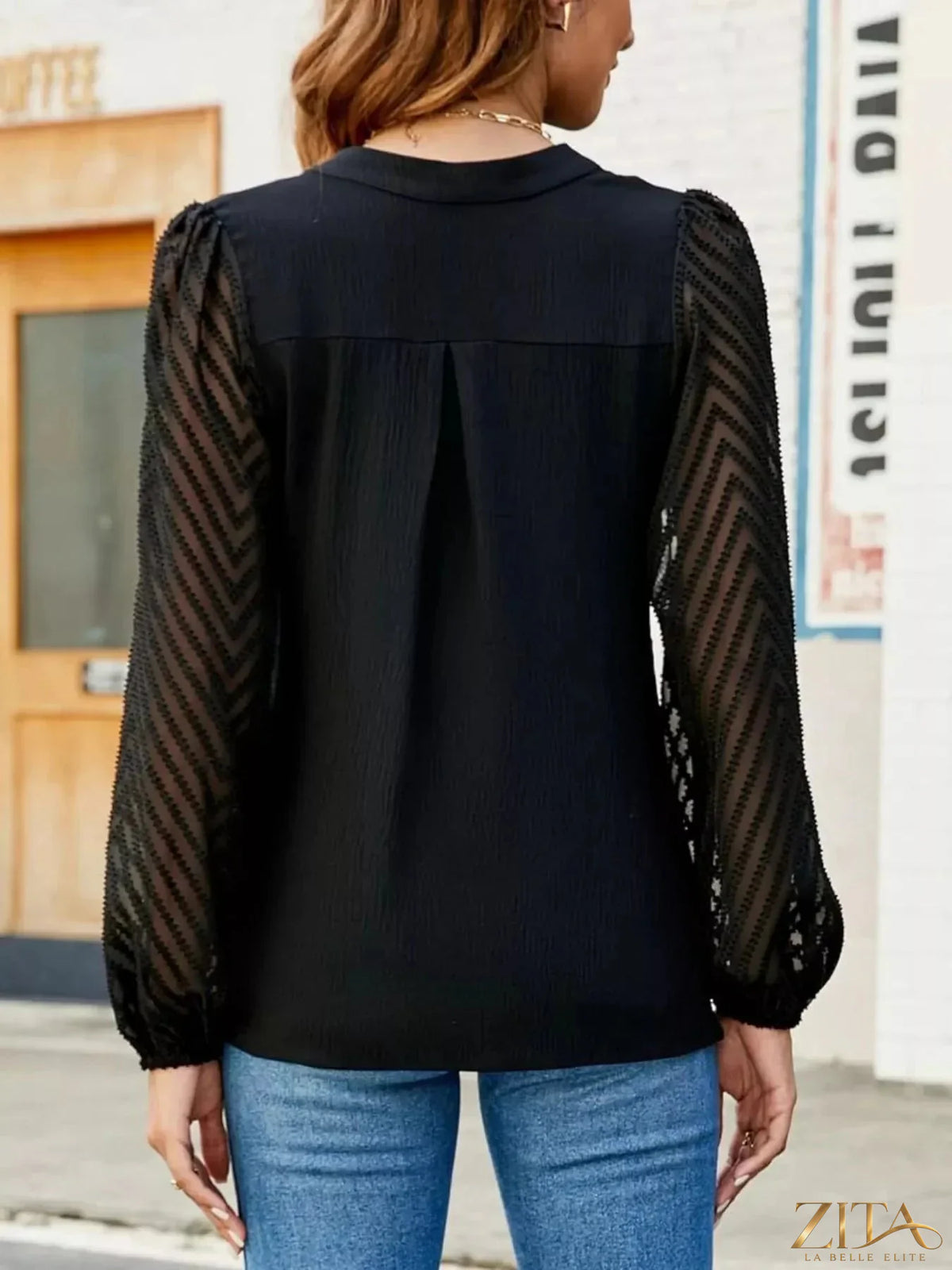 Zita La Belle Elite notched balloon sleeve blouse with ruffled details, soft fabric, and stylish design, shown on a mannequin.