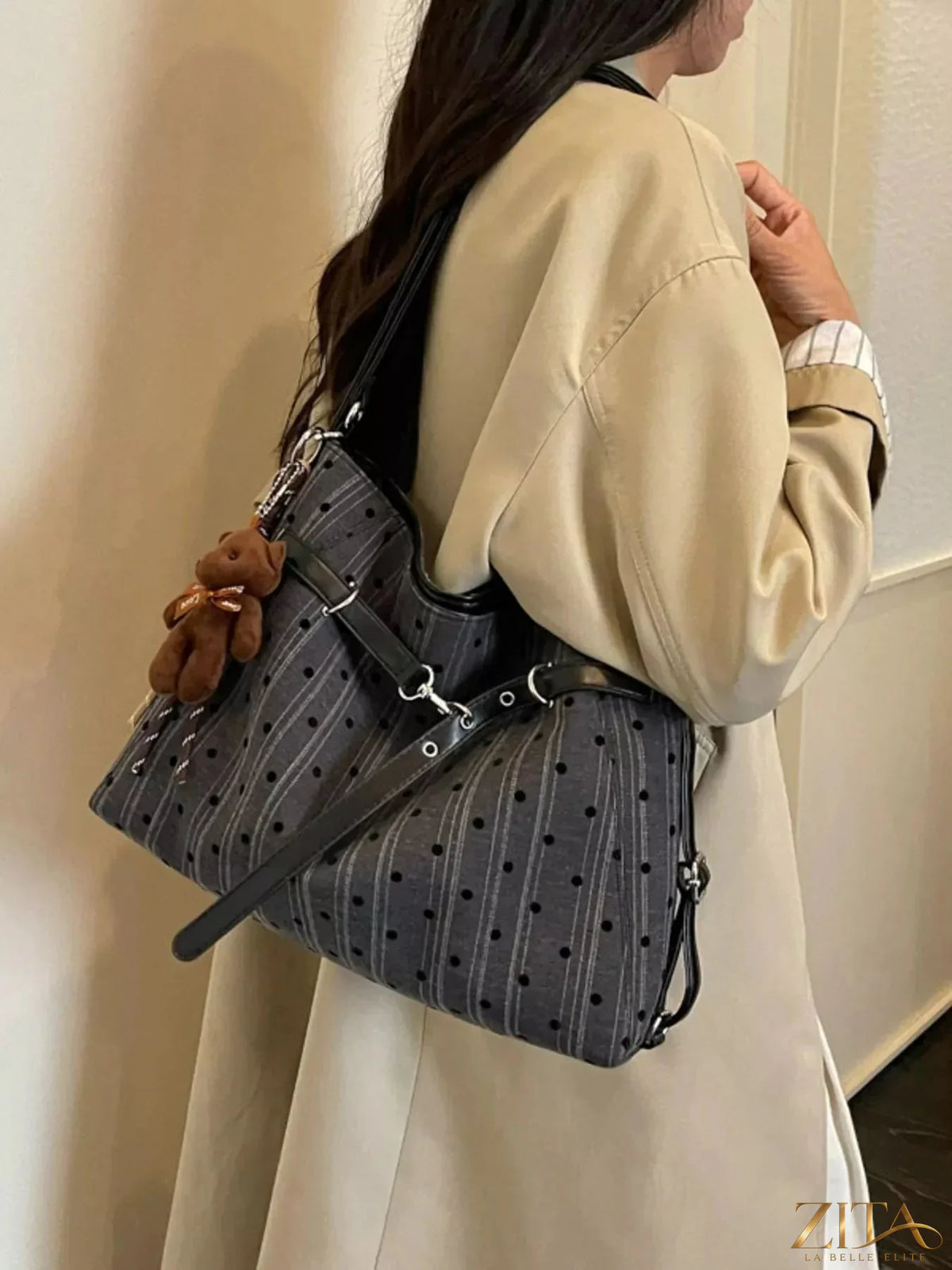Zita La Belle Elite polka dot shoulder bag with adjustable strap and stylish design, featuring a black and white dotted pattern.