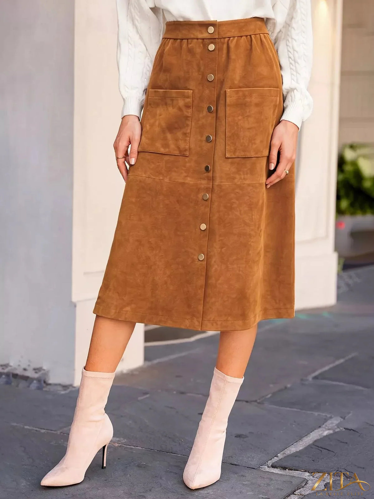 Button-front midi skirt by Trendsi featuring a flowy fabric and a stylish row of buttons down the front.
