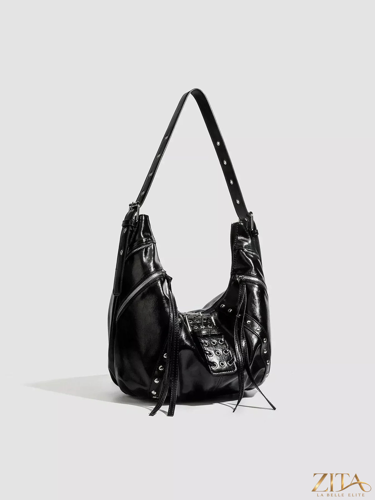 Zita La Belle Elite studded patent leather hobo shoulder bag with silver hardware and a slouchy design.