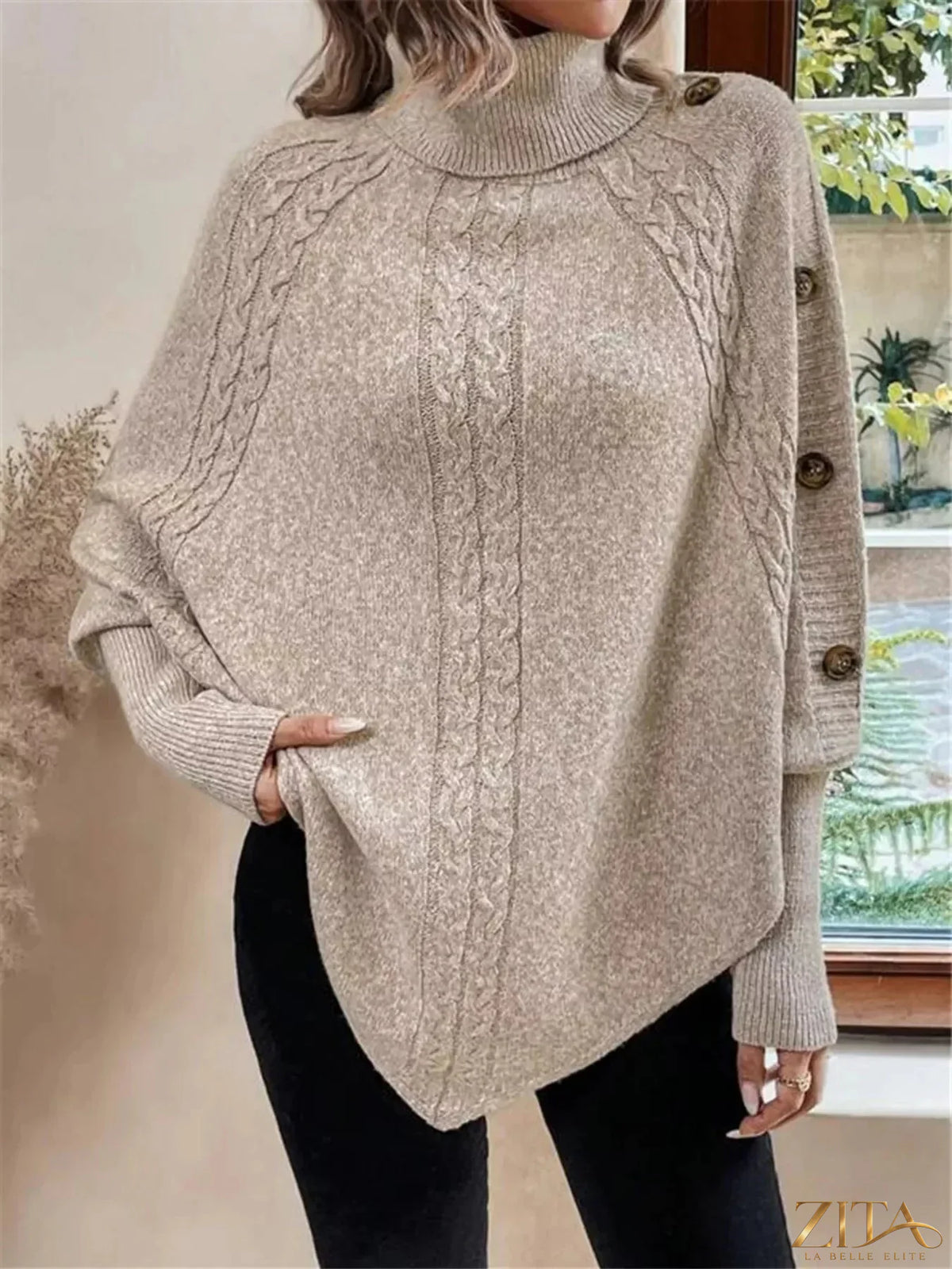 Cable knit turtleneck cape sweater by Trendsi, featuring a cozy, oversized design with a high neckline and textured knit pattern.