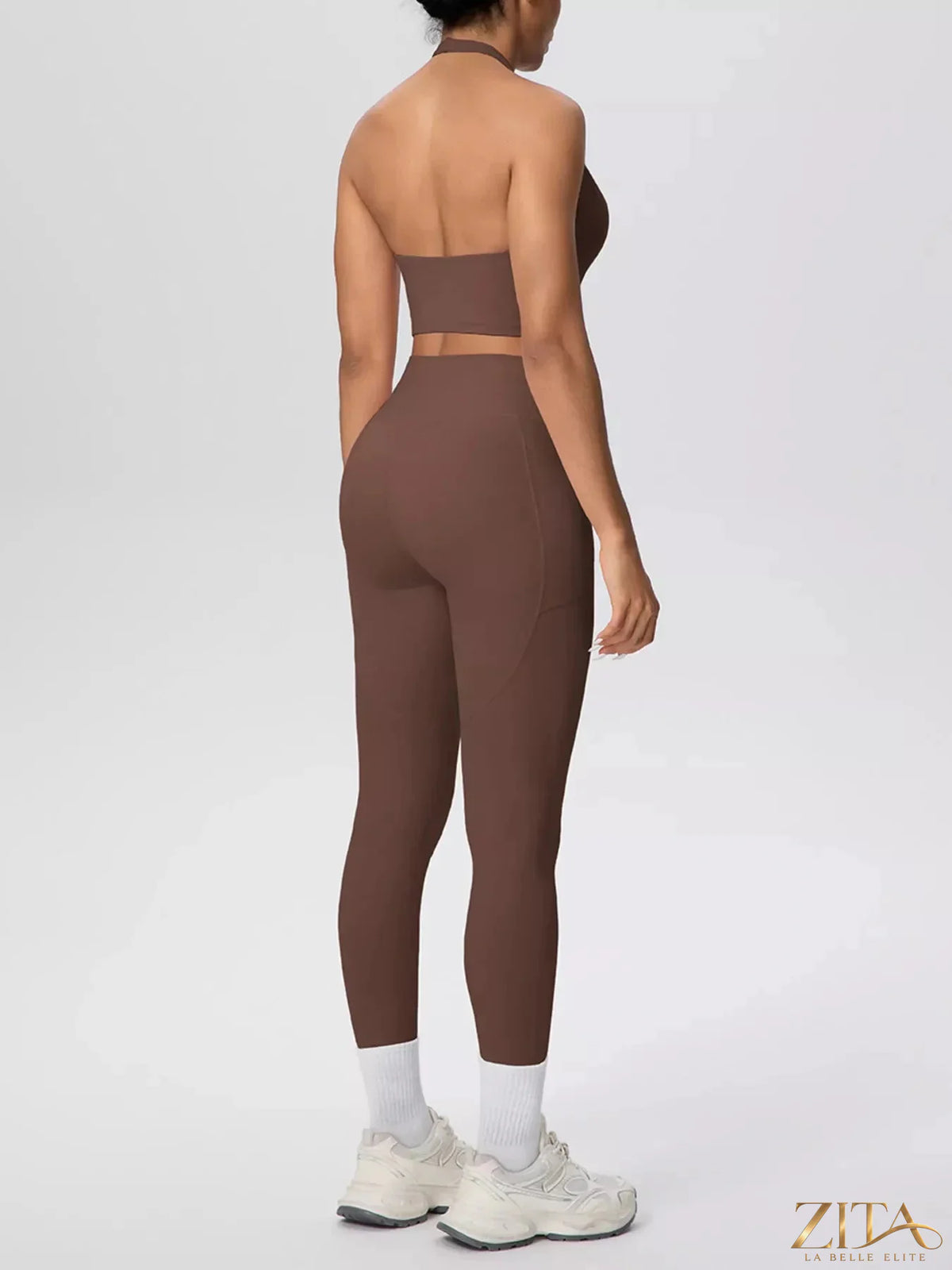 Zita La Belle Elite halter neck crop top and high-waisted leggings active set on a model, showcasing sporty and stylish athletic wear.