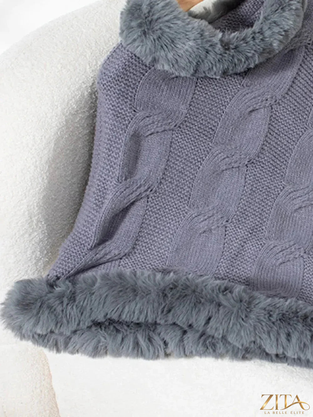 Fuzzy hem cable-knit poncho by Trendsi featuring a cozy, textured design with a relaxed fit and stylish hem detailing.