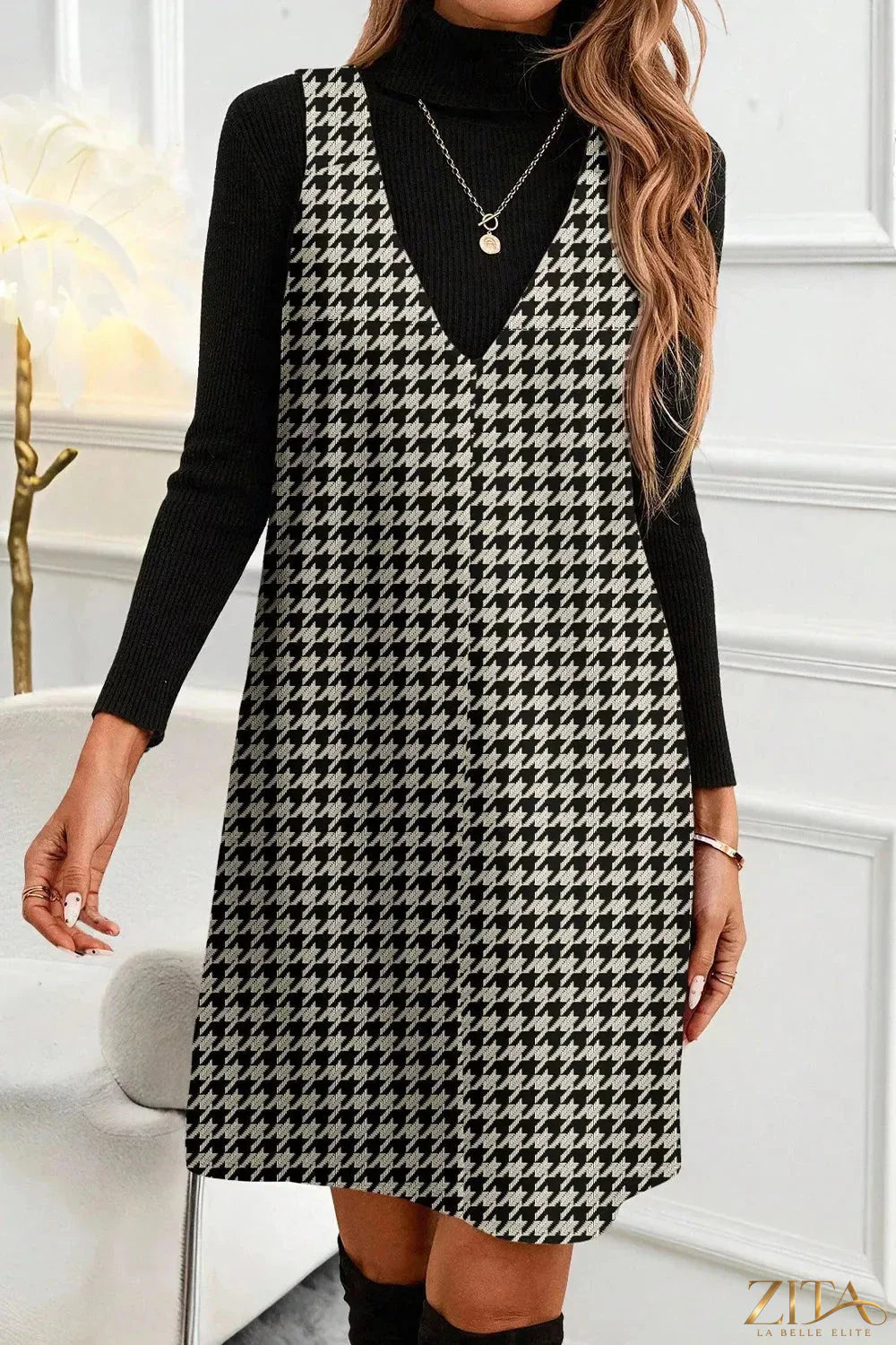 Houndstooth V-neck sleeveless mini dress by Trendsi with a fitted silhouette and classic pattern, displayed on a mannequin.