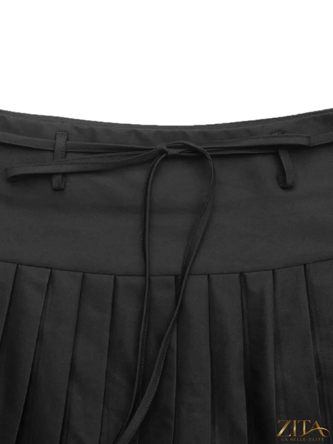 Tied pleated mini skirt from Trendsi featuring a stylish design with a tied front and pleated detailing.