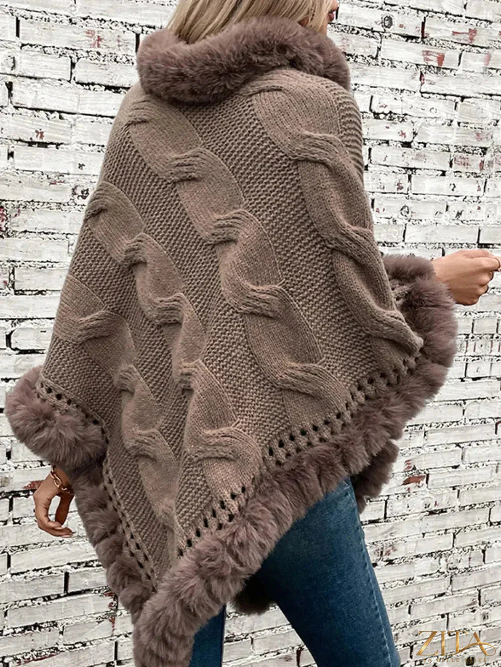 Fuzzy hem cable-knit poncho in soft, cozy fabric featuring a relaxed fit and stylish design, perfect for layered winter looks.